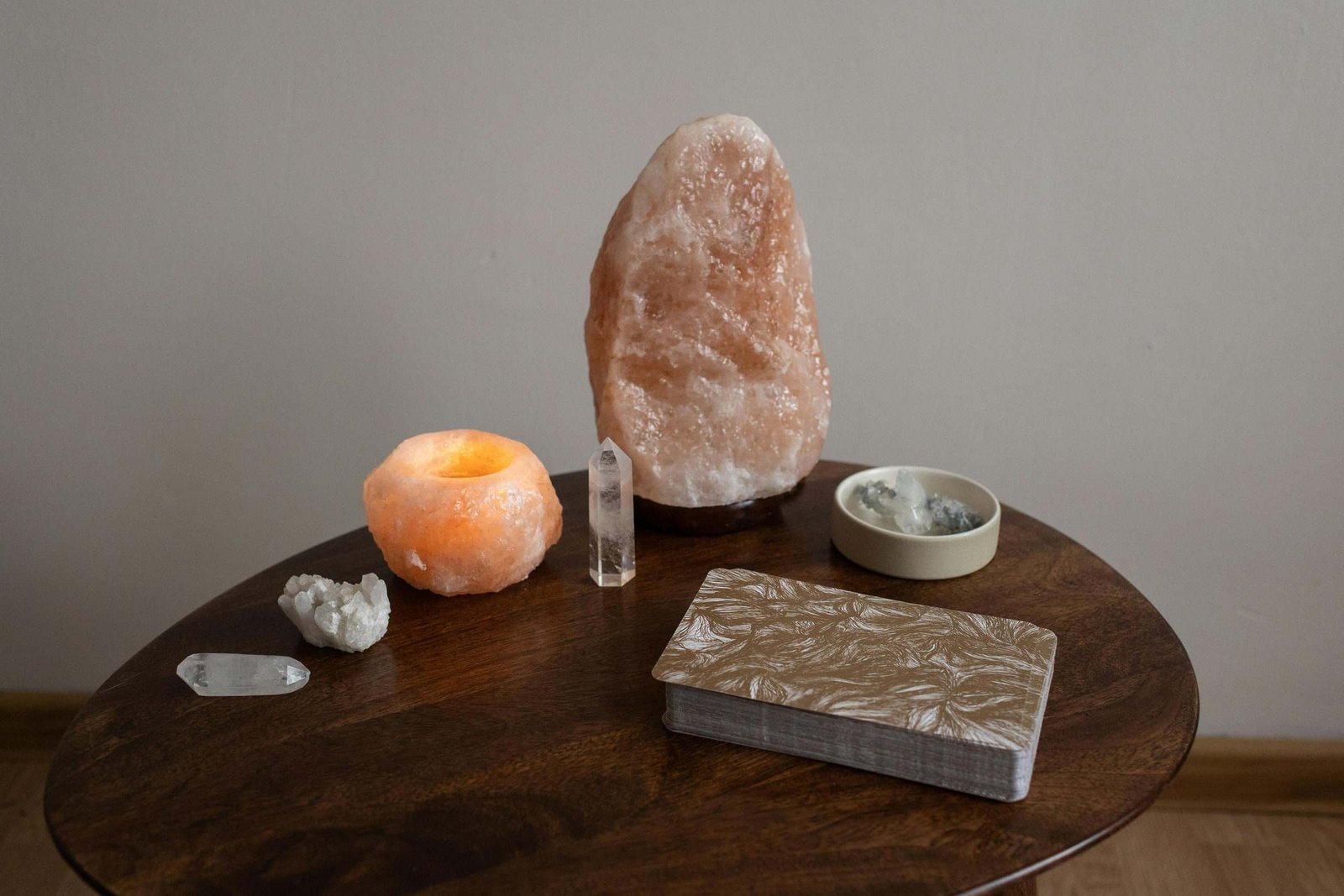Salt lamp and candle holder on a wooden table